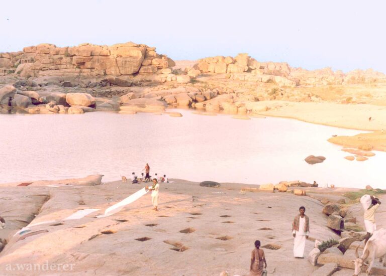 Locals do laundry on the banks of the Tungabhadra River in Hampi, India
