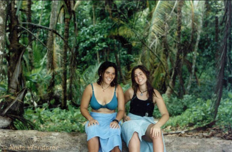 Smiling girls on a beach in front of the rainforest in Costa Rica