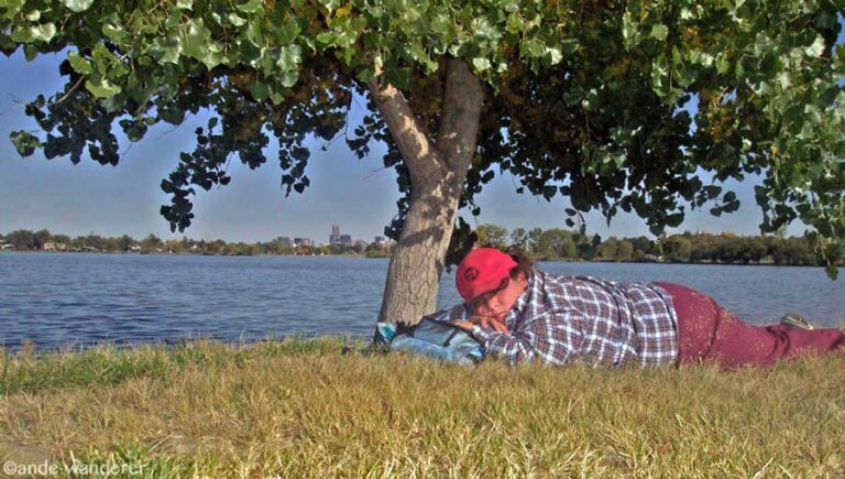 Homeless teen napping under a tree in Denver