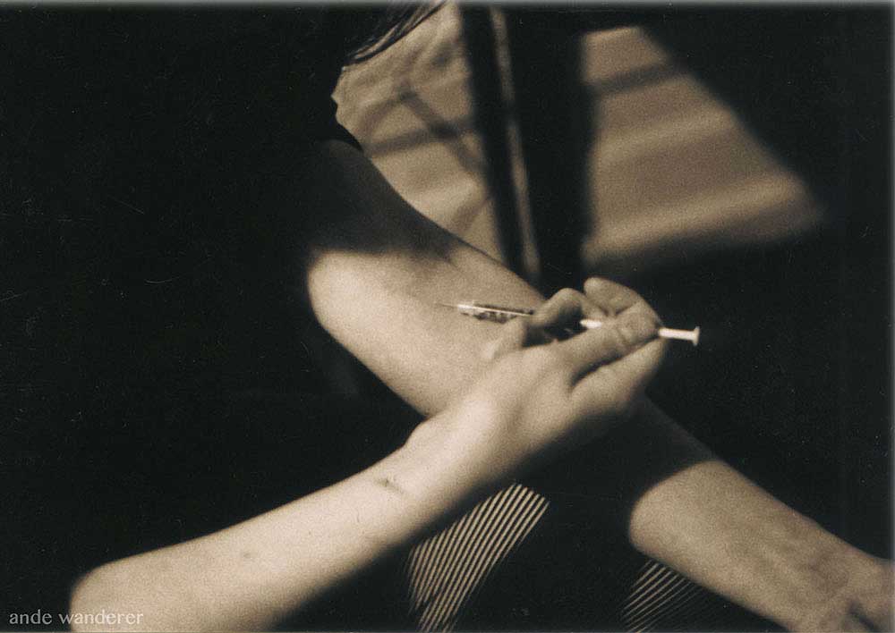 A drug user injecting heroin (black and white)